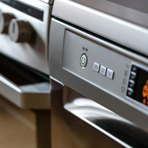 close up picture of an on/off button on dishwasher