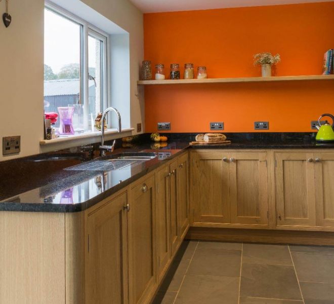 orange kitchen with wooden cupboards