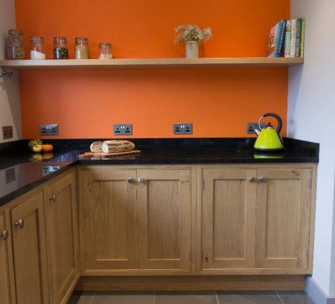 orange kitchen with wooden cupboards