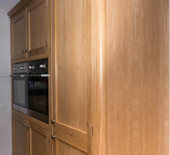 oven fitted into wooden cabinet