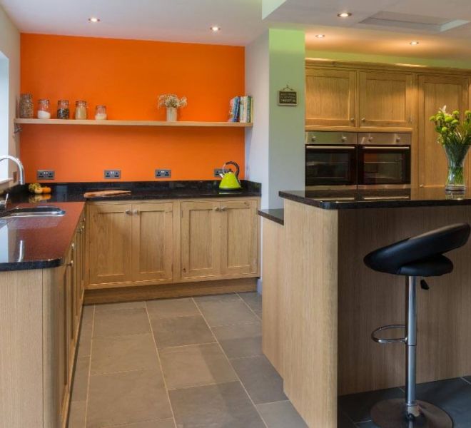 orange kitchen with wooden cupboards