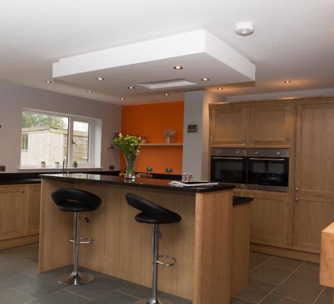 wooden kitchen with orange walls