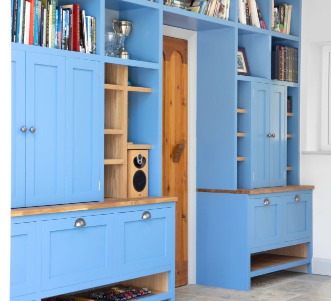 fitted blue furniture with books stacked around it