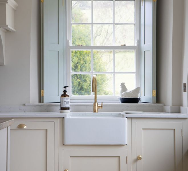 light color sink with a hand soap on top