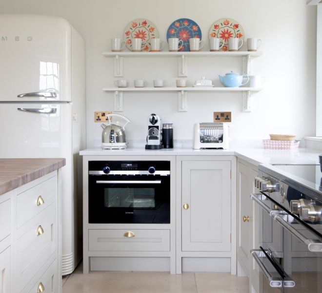 withe kitchen with decorations and a black oven